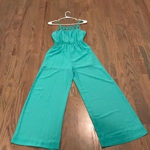 A teal wide leg jumpsuit with a detailed neckline